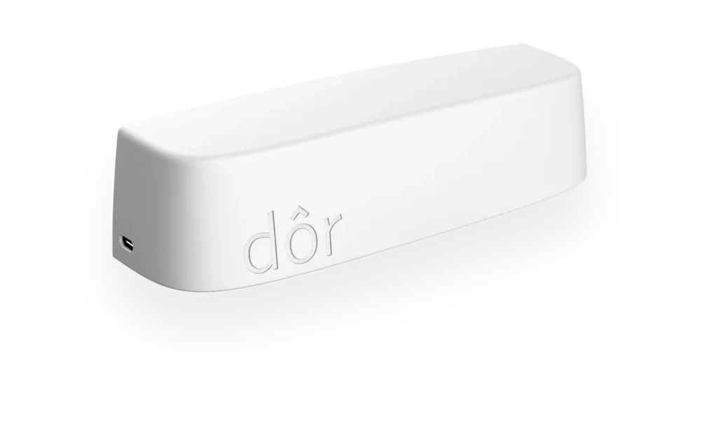 The Dor sensor, a compact white bar with the dôr logo.